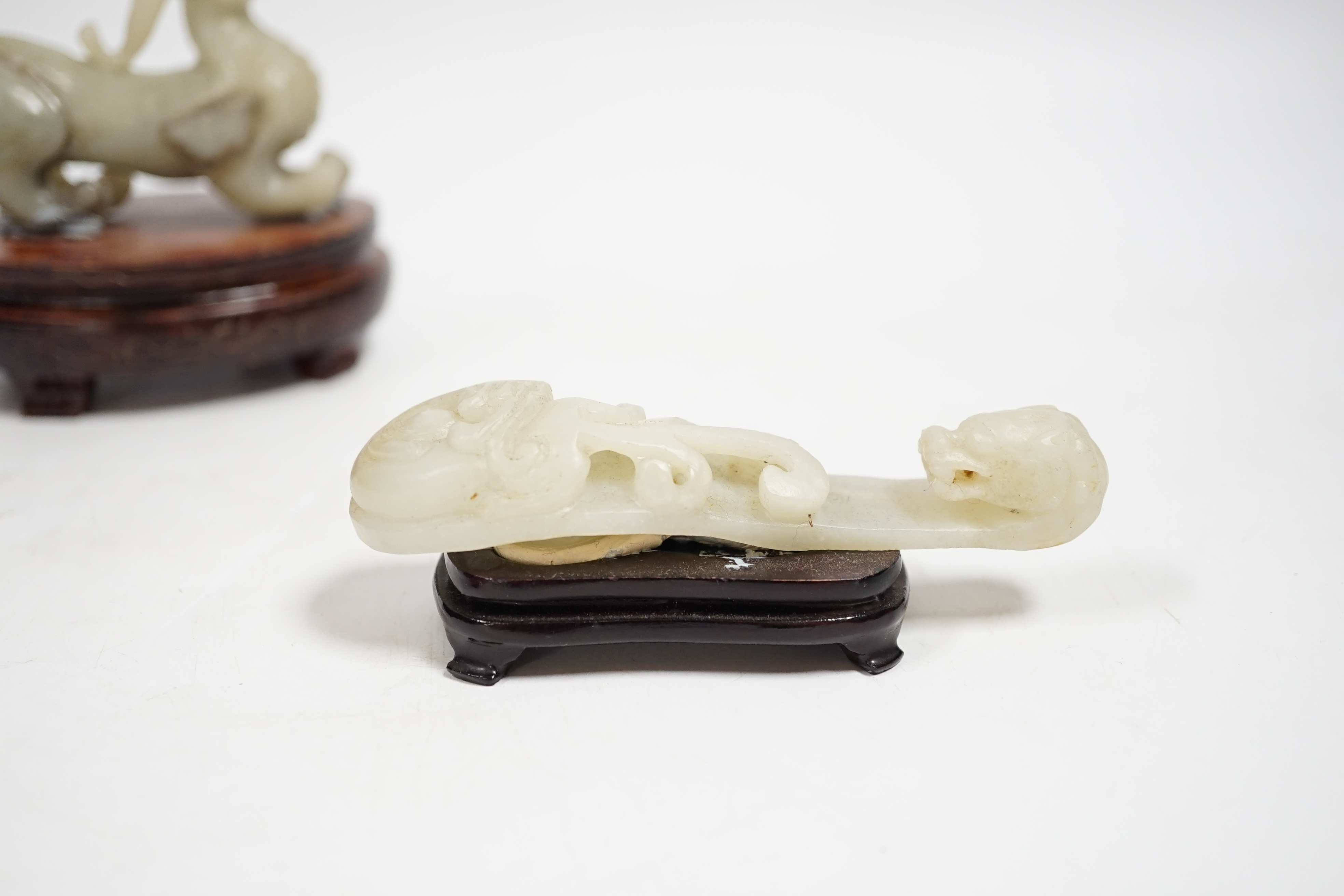 A Chinese pale celadon and grey jade mythical beast on stand, and a pale celadon jade belt hook, mythical beast 11cm wide